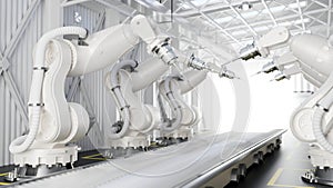 Robot arms in a production line over a conveyor belt in a modern factory. Automated manufacturing