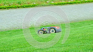 Robot automatic lawn mower mows the grass.