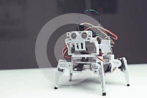 Robot close up. A small gray robot is on the table
