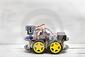 Robot on four wheels and the various conductors photo