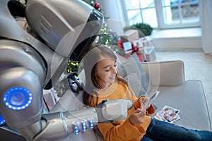 Robot and girl having good time at home