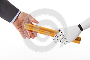 Robot Hand Giving Baton To Businessperson