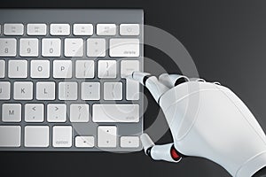 Robot hand typing on a computer keyboard