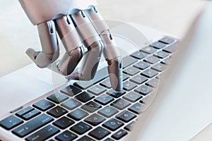 Robot hands and fingers point to laptop button advisor chatbot robotic artificial intelligence