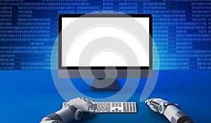 Robot hands using keyboard in front of a computer monitor with b