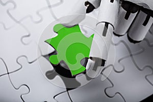 Robot Holding Green Jigsaw Puzzle