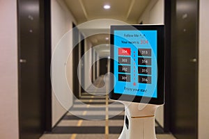 Robot in hotel concept, robotic butler help the customer to the room that booking, put the object, food, accessories inside it.