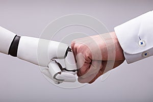 Robot And Human Hand Making Fist Bump