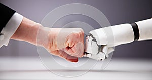 Robot And Human Hand Making Fist Bump
