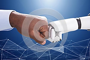 Robot And Human Hand Making Fist Bump