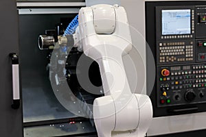 Robot loading the workpiece into CNC lathe machine
