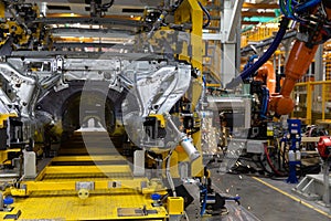 The robot makes welding of the car body. Assembly line