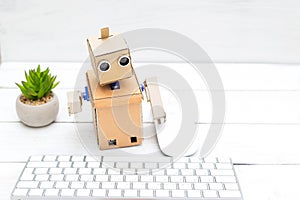 robot - office worker and his workplace with a keyboard and mouse