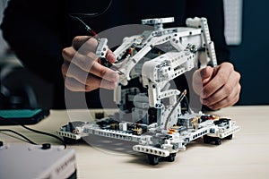 robot, in the process of being programmed, with the programmer making adjustments to its set of instructions