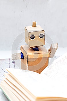 Robot with hands read book. Artificial Intelligence