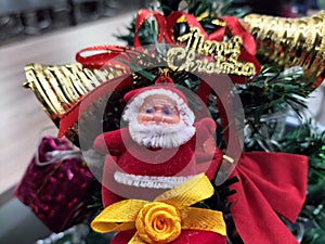 Robot Santa Christmas ornament on green Christmas tree with firetruck ornament in background