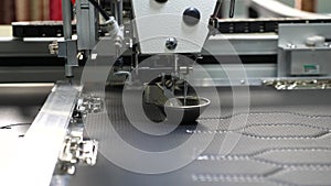 Robot sewing machine. automatic sewing machine. Robotics works in the tailoring production line. The computer controls