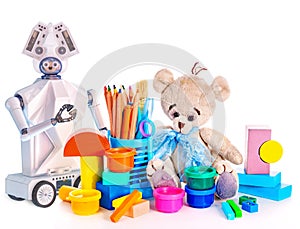 Robot toy and stuffed animals teddy bear and color pencils and cans of paint.