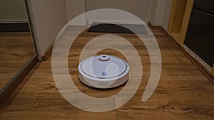 Robot vacuum cleaner cleans the hallway