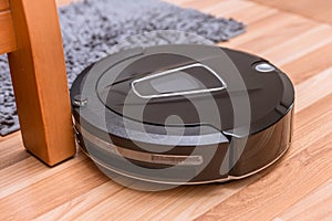 Robot vacuum cleaner on laminate wood floor