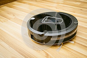 Robot vacuum cleaner on laminate wood floor