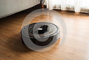 Robot vacuum cleaner on wood,laminate floor.Smart life concepts