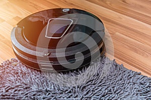 Robot vacuum cleaning the floor with doormat automatic home cleaning machine