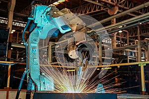 Robot is welding metal part in car factory