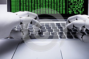 Robot Working On Laptop