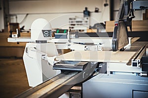 A robot works fully automatically in a carpentry workshop