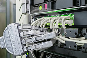 The robot works in the server room. A mechanical hand switch wires in the data center. A metal arm connects wires to the main