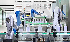 Robotic arm holding water bottles on production line in factory, Industry 4.0 concept photo