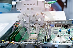 Robotic arm installing a computer chip