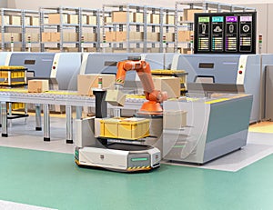 Robotic arm picking parcel from conveyor to AGV photo