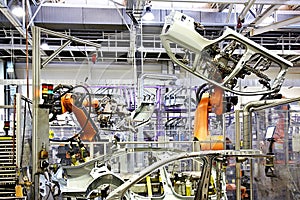 Robotic arms in a car factory photo