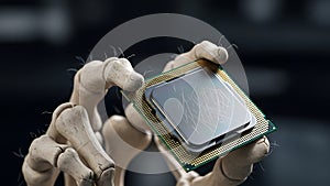 A robotic hand holds a computer processor chip in a dark background