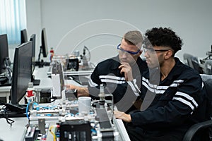 The robotic hand technology teacher is instructing new students on how to use electronic circuit boards and robotic hand commands