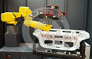 Robotic industry. Robot with 3D sensor scanner measures surface of detail in automotive industry photo