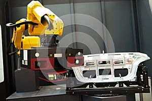 Robotic industry. Robot with 3D sensor scanner measures surface of detail in automotive industry photo