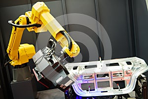 Robotic industry. Robot with 3D sensor scanner measures surface of detail in automotive industry photo