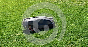 Robotic lawn mower on grass, side view