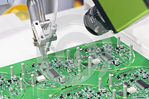 The robotic system for the soldering process with the electronics board.