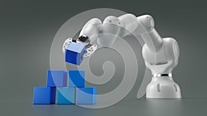 Robotics arm stacking blank blue cubic blocks on grey background.