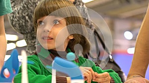 Robotics and child. education, children, technology, science and people concept. Cute little boy looks at the electronic