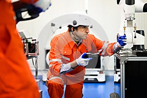 Robotics controller engineers working and solving problems on machine