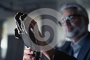 Robotics engineer adjusting, calibring robotic prosthetic hand. Concept of modern technology in medicine. Robotic