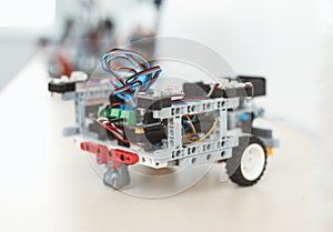Robotics. Robot car on table isoalated close-up modern technology blurred