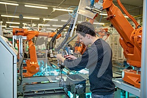 Robotization of modern industry in the factory. Introduction of new robotic arms to replace human resources