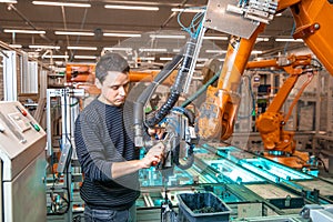 Robotization of modern industry in the factory. Introduction of new robotic arms to replace human resources