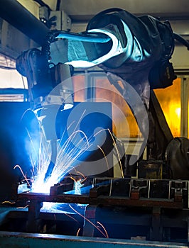 Robots welding in a car factory